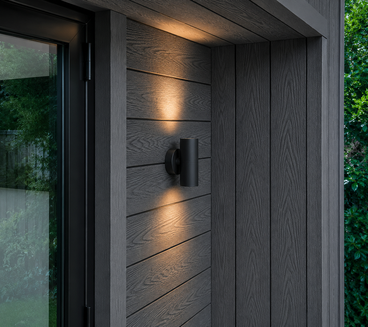Dark grey composite cladding installed around a modern doorway