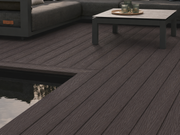 Coffee composite decking beside an outdoor sofa and reflecting pond