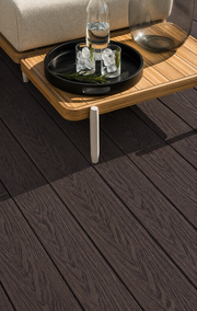 Close-up of coffee composite decking beneath a side table