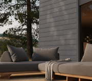 Dark grey composite cladding beside covered outdoor seating