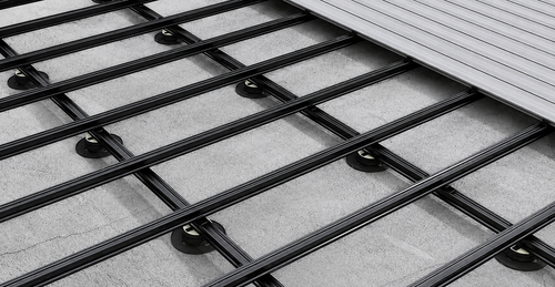Black composite joists installed beneath decking boards