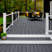 Dark grey composite decking on a raised terrace with white railings