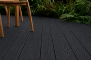 Close-up of charcoal composite decking beneath outdoor furniture