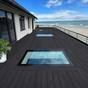 Charcoal composite decking on a coastal rooftop terrace