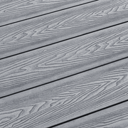 Close-up of light grey composite decking woodgrain surface