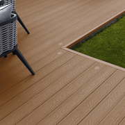 Coffee composite decking laid beside a lawn