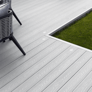 Light Grey composite decking laid beside a lawn