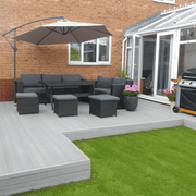Light Grey composite deck with garden seating and a parasol