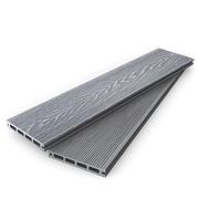 Stacked light grey composite decking boards showing woodgrain and grooved faces