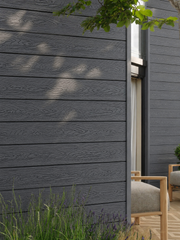 Close-up of dark grey composite cladding beside an entrance