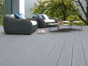 Light grey composite decking with outdoor sofas and trees
