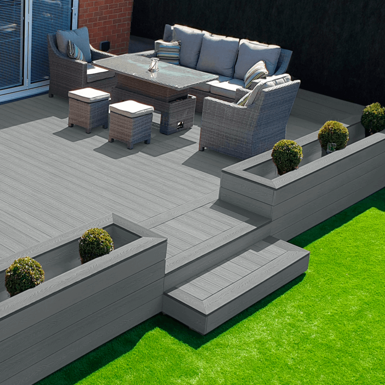 Raised dark grey composite deck with steps, seating and planters