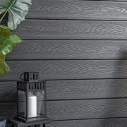 Close-up of dark grey composite cladding woodgrain surface